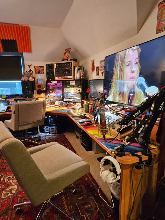 The recording desk with the TV, monitors and microphone.