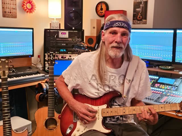 Steve smiling with his red Stratocaster.